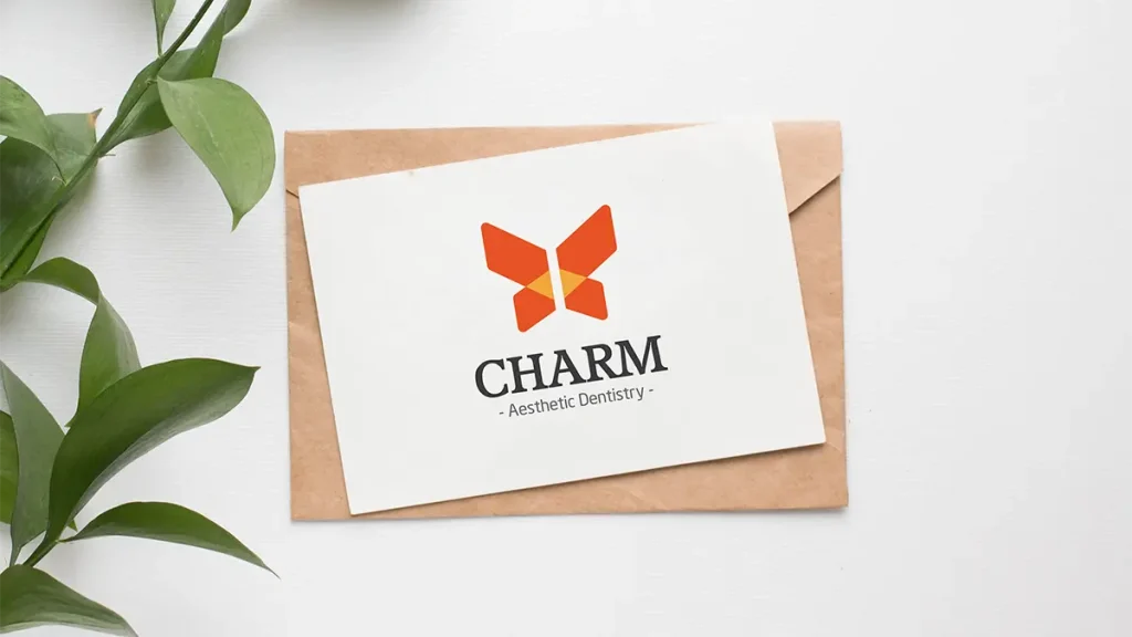 A stationery card featuring the Charm logo printed on white paper with a kraft envelope background