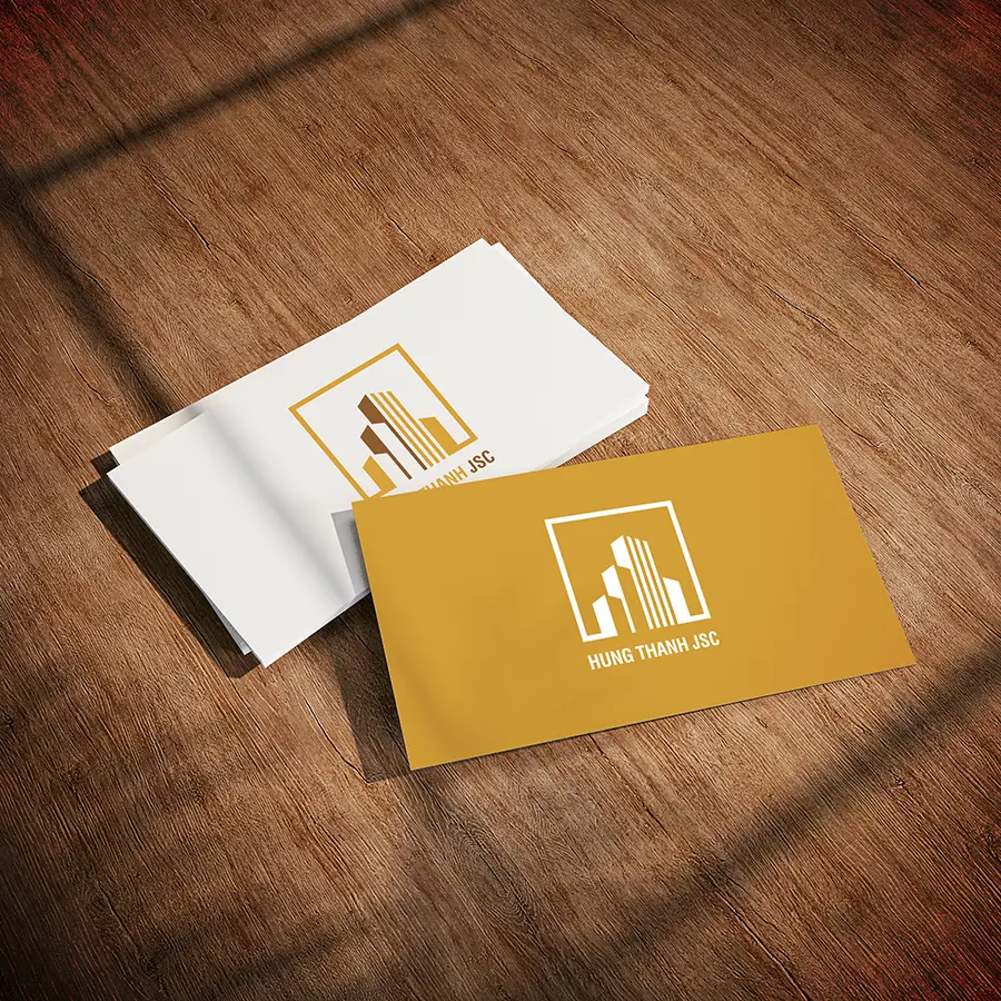 Hung Thanh real estate logo applied on business cards demonstrating clarity consistency and professional brand use